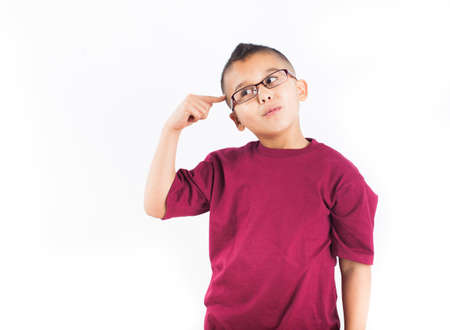 Hispanic child in thought Isolated on white background  Boy wearing glasses with a big Ideaの写真素材