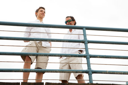 Father and son together on a pier
