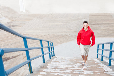 Smiling Teenager  walking from the boardwalk up stairs