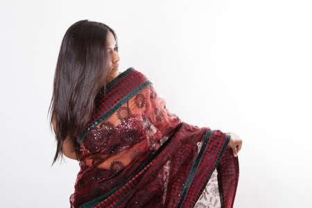 Profile side view of a Gorgeous young Indian Woman in traditional Dress isolated on whiteの写真素材