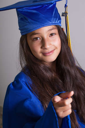 Pretty young graduate in Blue cap smiling 2013 on her tasselの写真素材