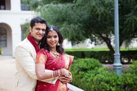 Gorgeous Indian bride and groom looking at cameraの写真素材