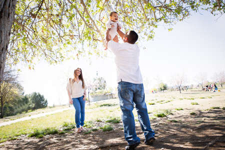 Cherry Blossoms surround a Beautiful young family in Spring timeの写真素材