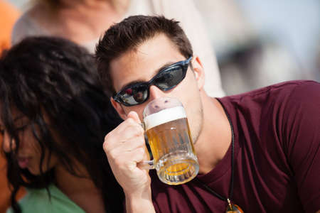Attractive Man and woman with a beer at an outside cafe on the Beach in Venice Californiaの写真素材