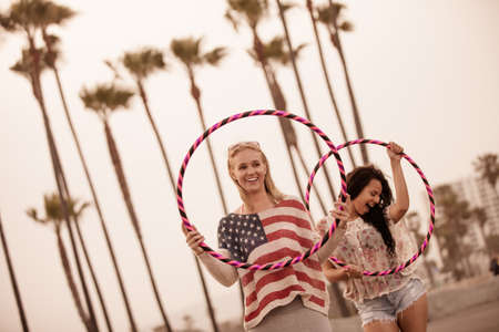 Young Friends on the boardwalk at the Beachの写真素材