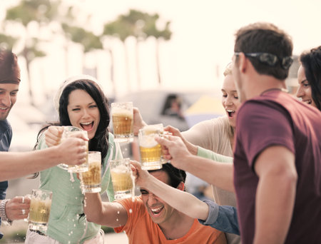 Group of Attractive young People toasting with a delicious Pale Ale  Beer
