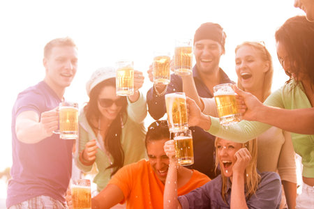Young People in their twenties on the Venice Beach boardwalk in California drinking beer