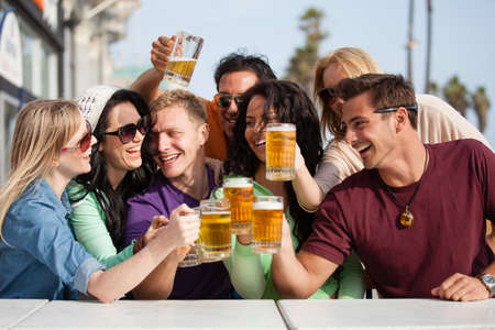 Young People in their twenties on the Venice Beach boardwalk in California drinking beerの写真素材