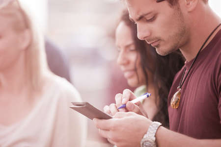 Attractive Guy signing the Check  with his friends at a Bistroの写真素材