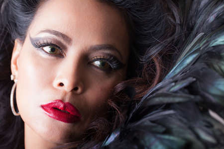 Beautiful  woman with Feathers and perfect red lipsの写真素材