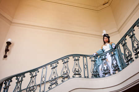 Portrait of a beautiful  woman with elaborate Marie Antoinette dress on a Balconyの写真素材