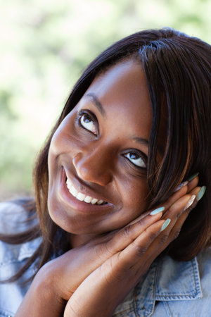 Pretty Woman dreaming hands in prayer next to face