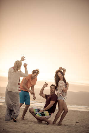 Group of Friends in their 20s Venice Beach at Sunset in Summer Dancing,vertical,の写真素材