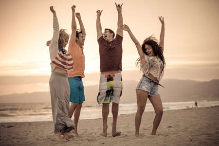 Group of Friends in their 20s Venice Beach at Sunset in Summer Dancing,vertical,の写真素材