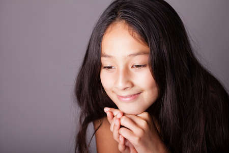 Preteen Portrait of a pretty girl in thoughtの写真素材