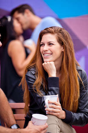 Focus on a Beautiful smiling woman with Long Hair engaged in a conversationの写真素材