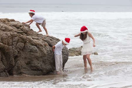 Children at the Beach in Xmas HatsMalibu,Californiaの写真素材