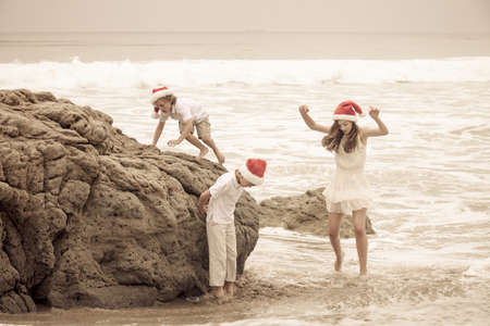 Children having Fun at the Beach Christmas Day in Malibu Californiaの写真素材
