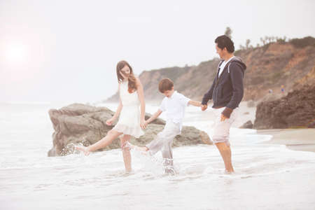 Father and his children at the beach in Malibu Californiaの写真素材