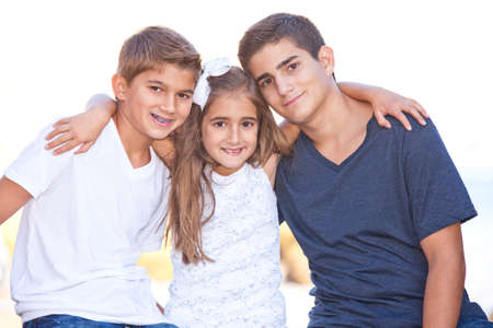 Two brothers and their sister at a southern california beachの写真素材