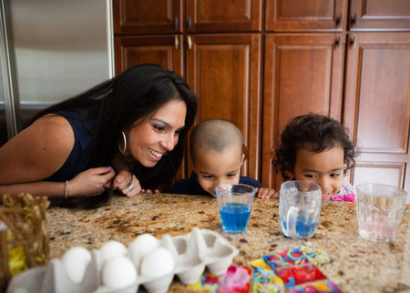 Young Family coloring easter eggs in Kitchen