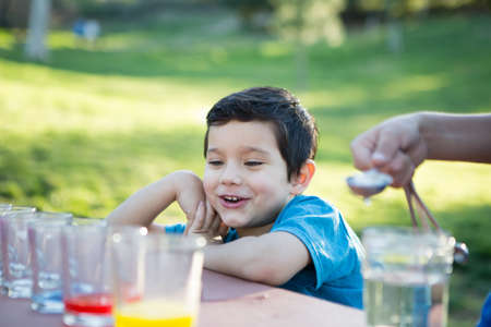 Children outside coloring Easter eggsの写真素材