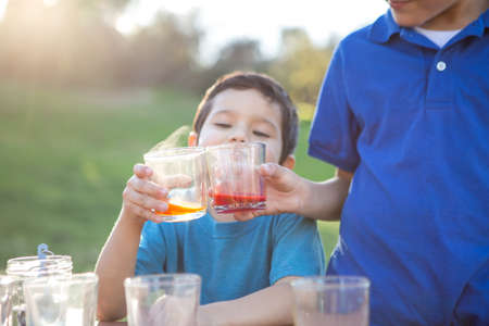 Children having fun coloring Easter eggsの写真素材