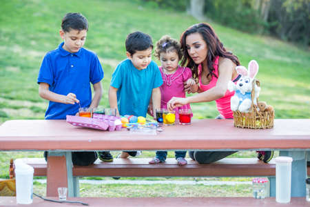 Family having fun coloring Easter eggsの写真素材