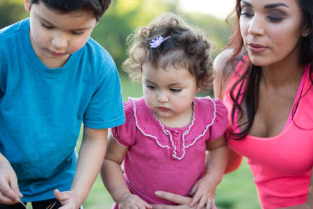 Family having fun coloring Easter eggsの写真素材