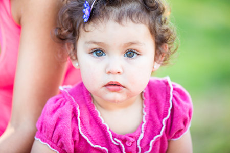 Cute Toddler girl in pink looking at camera