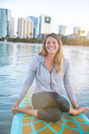 SUP Yoga practice early morning in Waikikiの写真素材