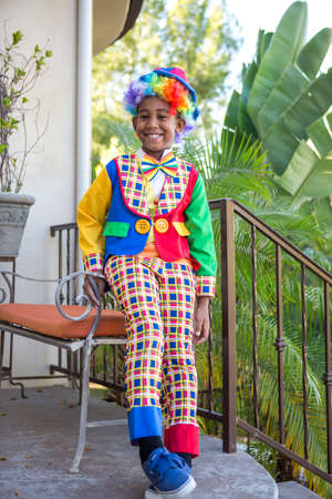 Smiling preteen boy in a colorful costume ready to trick or treatの写真素材
