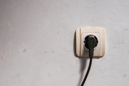electrical plug in the wall that is being used