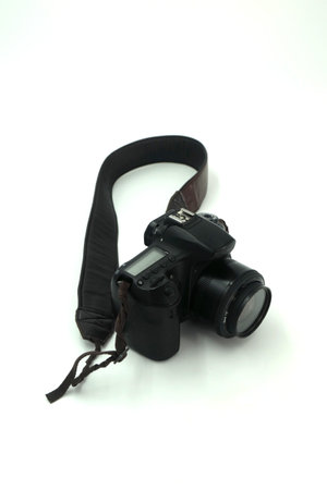 Black digital SLR camera in a white backgroundの写真素材