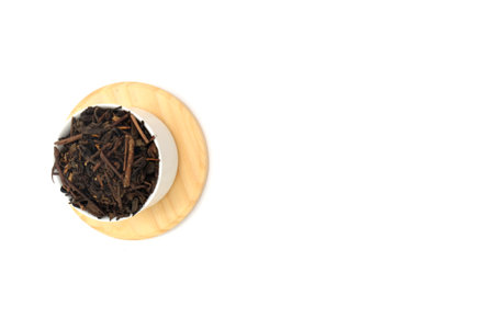 Dry black tea in round bowl isolated on white backgroundの写真素材