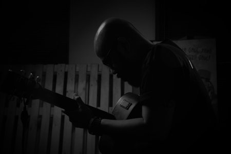silhouette of unknown person playing guitar
