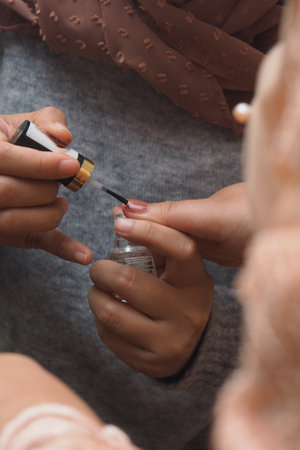 close up of fingers applying nail polishの写真素材