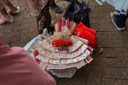 Money bouquet with artificial flowers. Colorful rupiah bouquet.