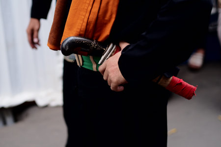 traditional clothing of javanese that appears close to the belt is a large knife