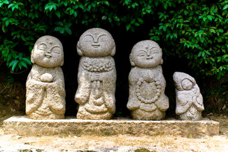 Four lplayful stone Buddhist statues in Arashiyama, Japanの写真素材