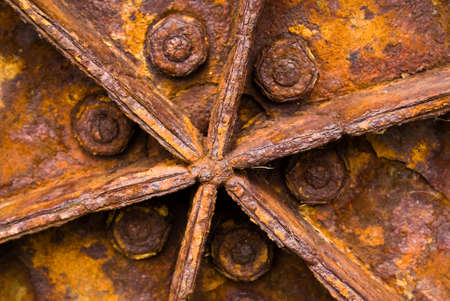 A close-up of a rusty tractor wheel showing the effects of exposure on metalの写真素材