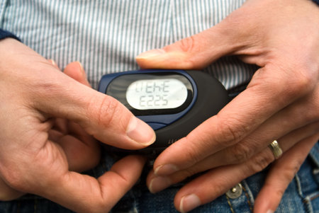 A pedometer with woman's hands