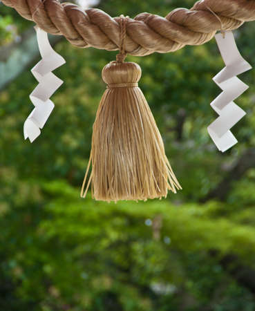 A rope and folded paper outside a shrine in Japanの写真素材