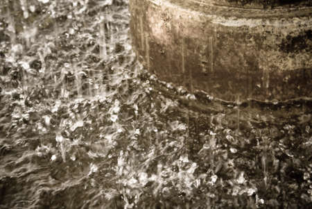 Closeup of a fountain spraying into its reservoirの写真素材