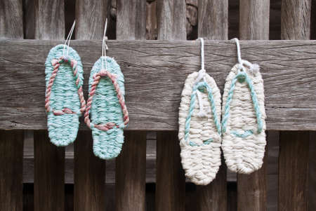 Two pairs of woven zori sandals hung outside a Japanese templeの写真素材