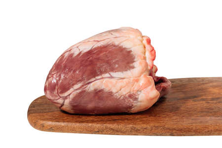 raw beef heart on a wooden board isolated on a white backgroundの写真素材