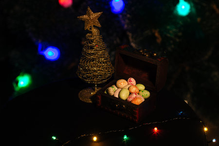 Wood Box with assorted delicious candy and garland for New Year and Christmas. New Year's sweets and...