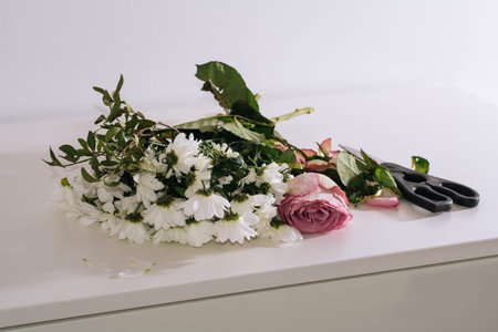 Bouquet of faded flowers on the white table