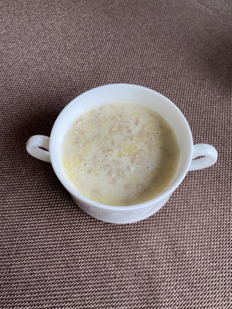 white plate with oatmeal on the tableの写真素材