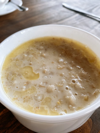 white plate with oatmeal on the wooden backgroundの写真素材